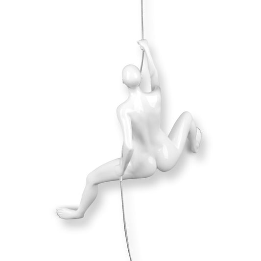 White female climber sculpture in resin, wall-mounted with steel cable, capturing dynamic rock climbing adventure with elegant white finish.